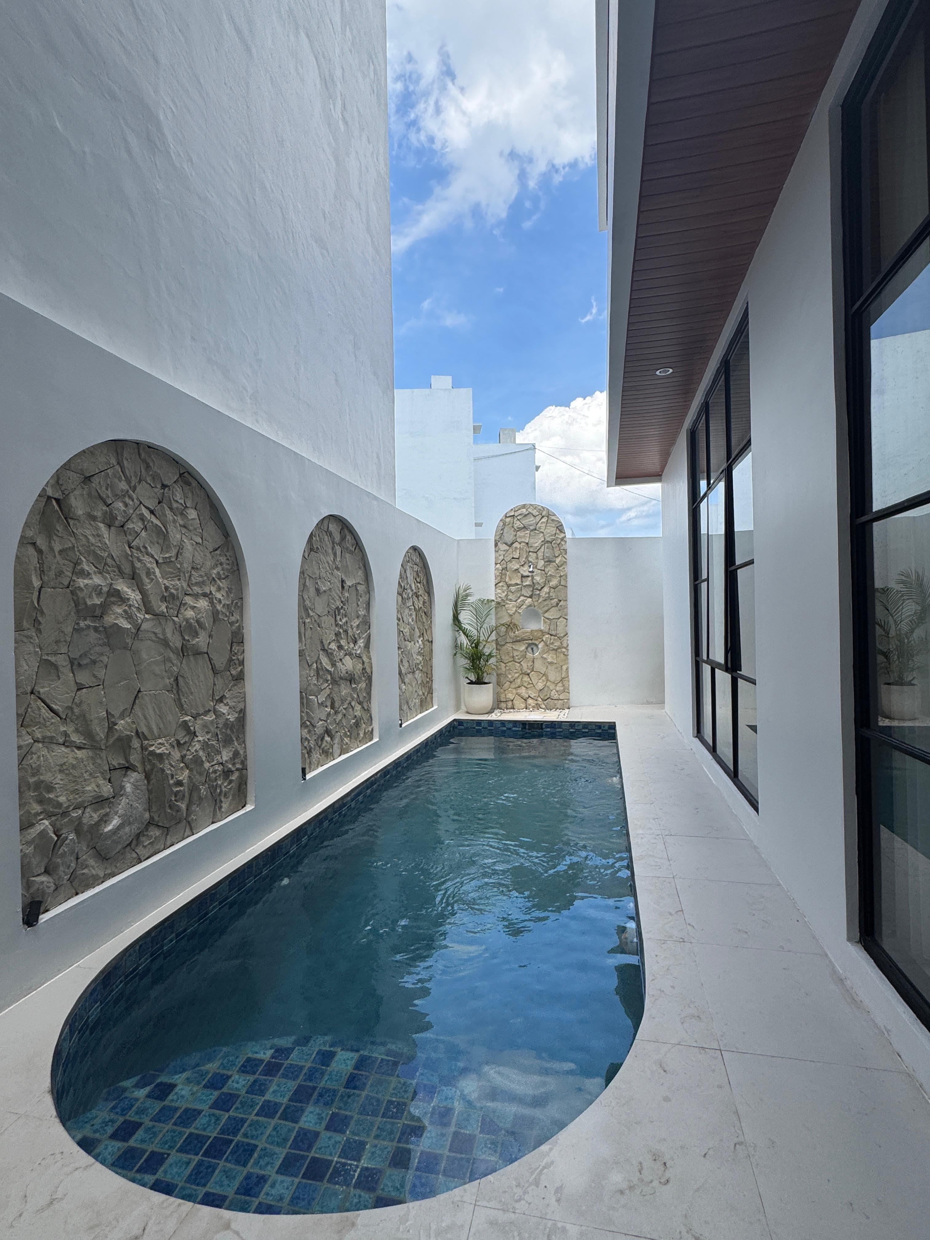 Infinity Villa — private pool with arched stone wall
