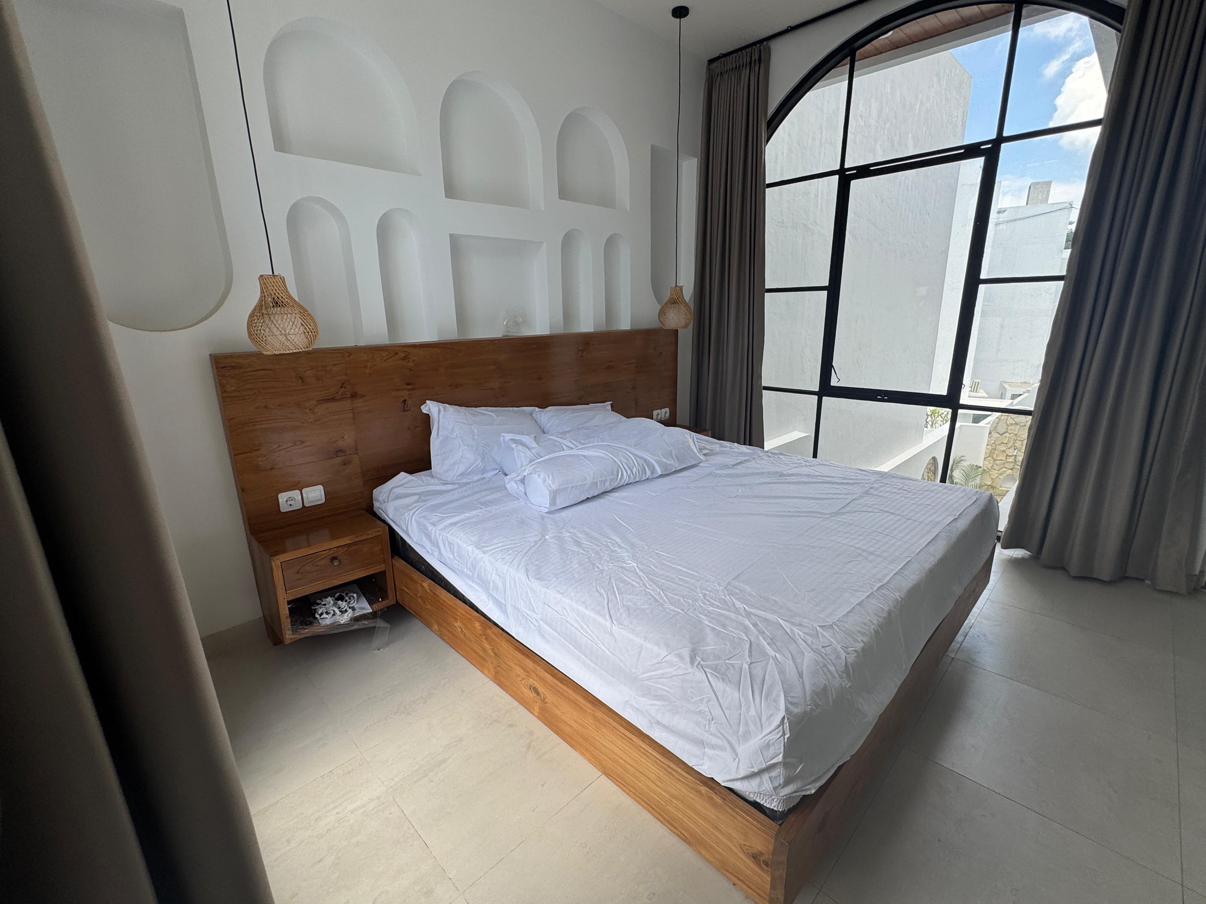 Infinity Villa — bedroom with arched window