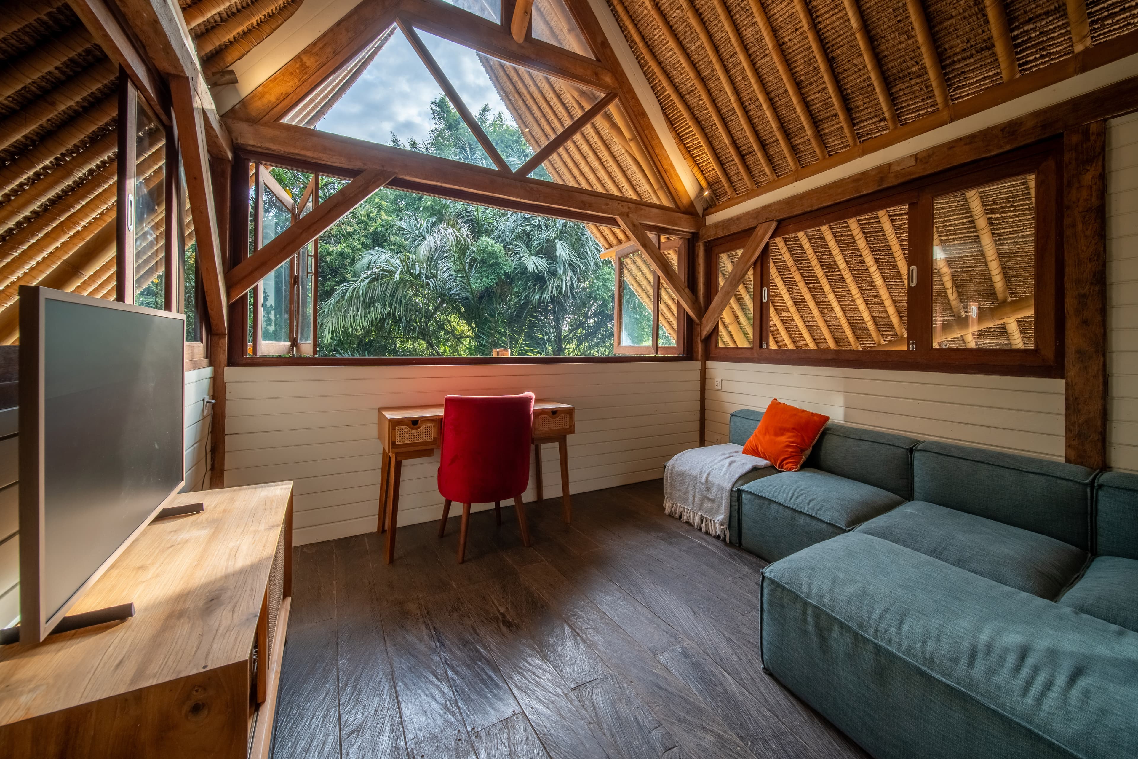 Kailash Villa — loft living room with bamboo roof and garden views