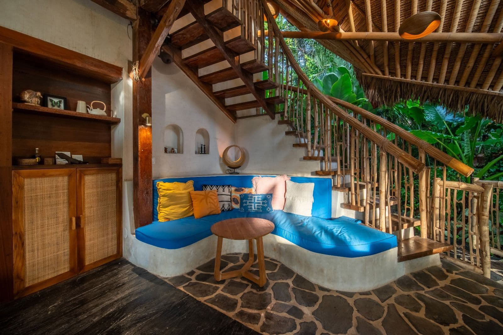 Kailash Villa — living room with bamboo staircase