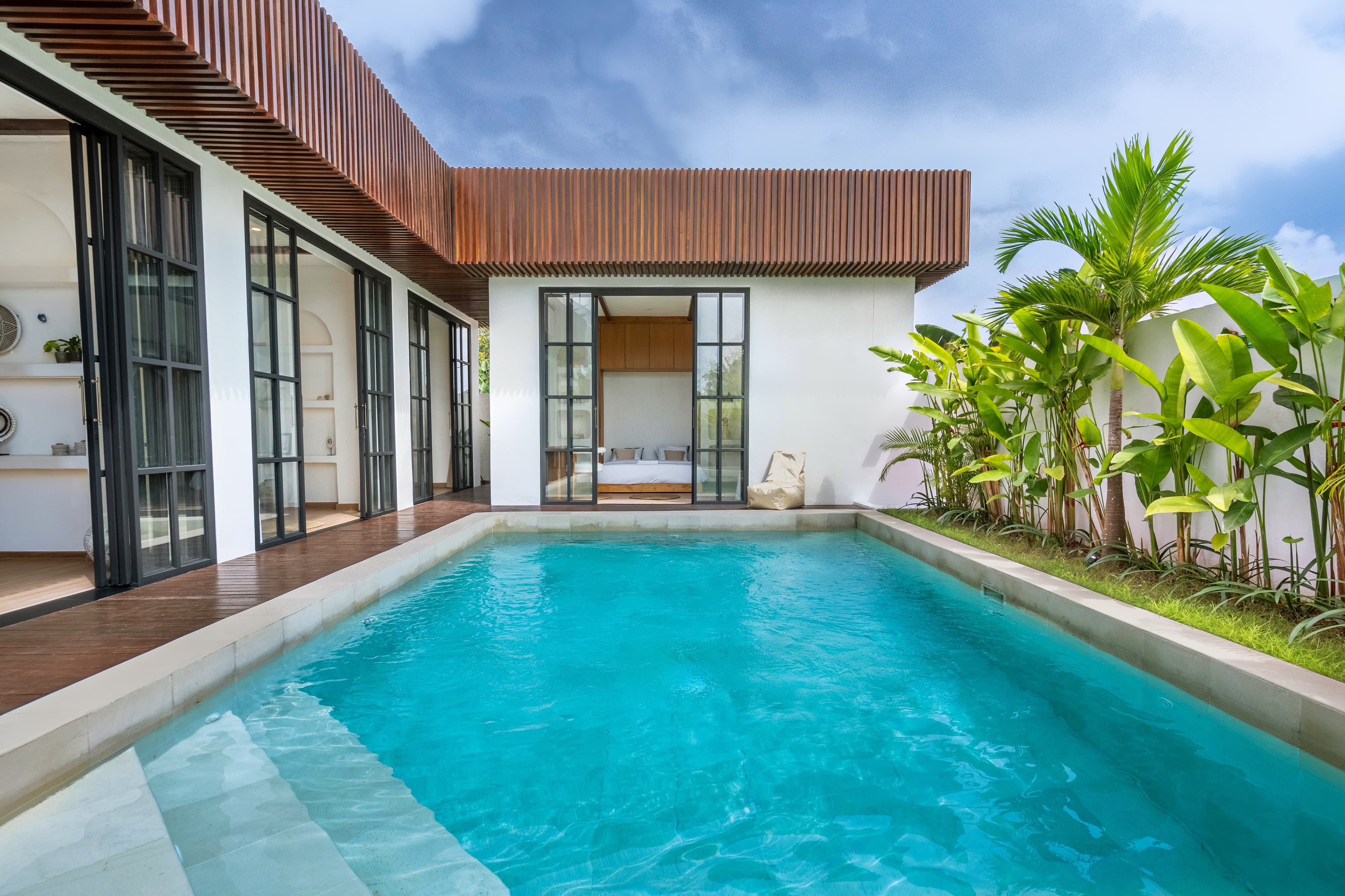 Palm Sugar Villa — pool deck with wood-slat roofline and bedroom access